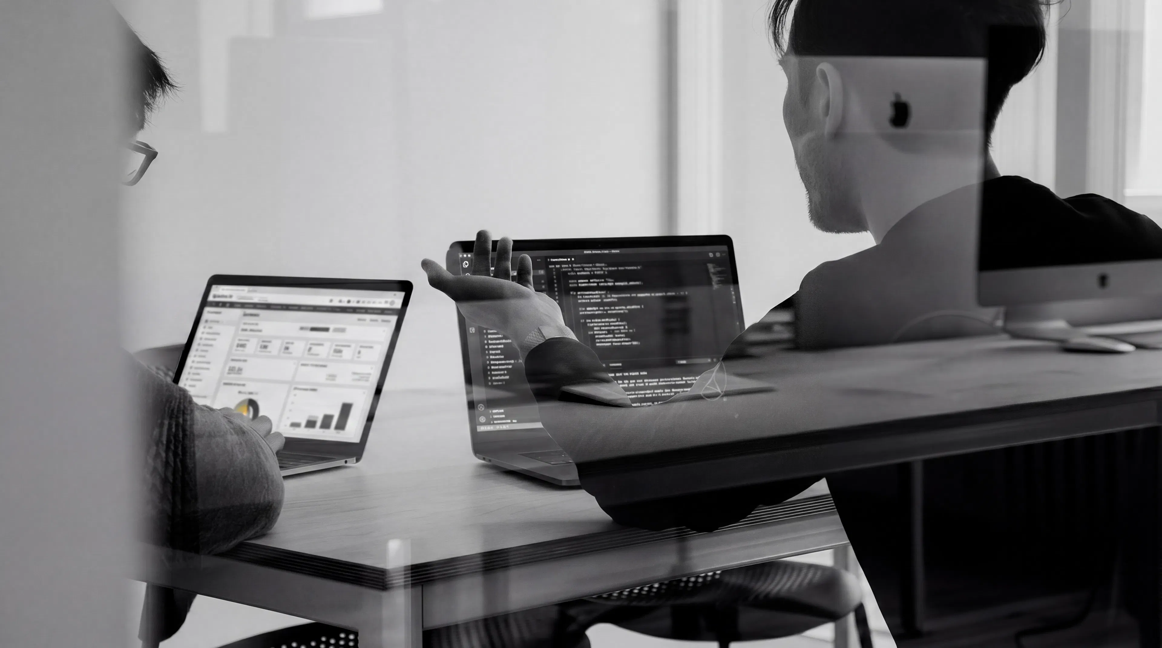 Laptops and notes on a desk during a NetSuite implementation working session