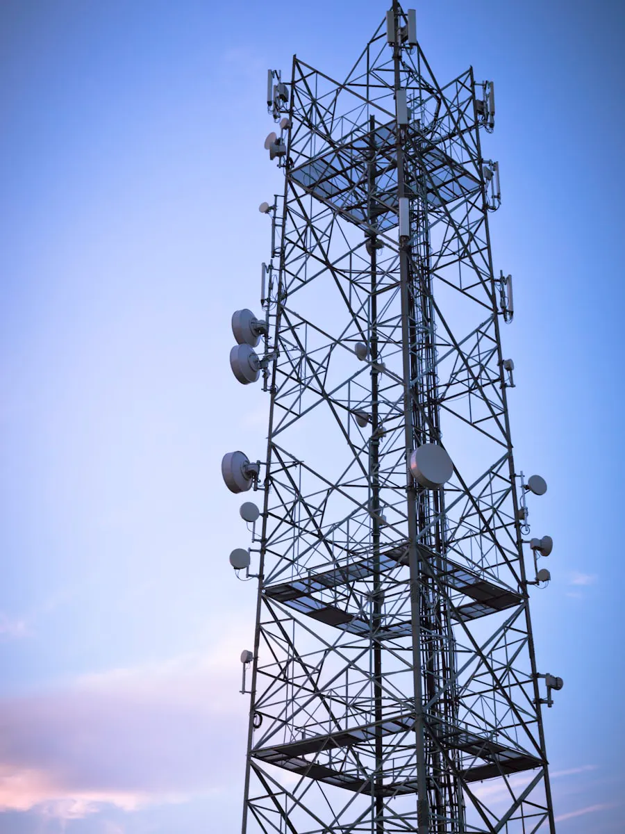 Lattice communications tower against an evening sky — P&R Communications