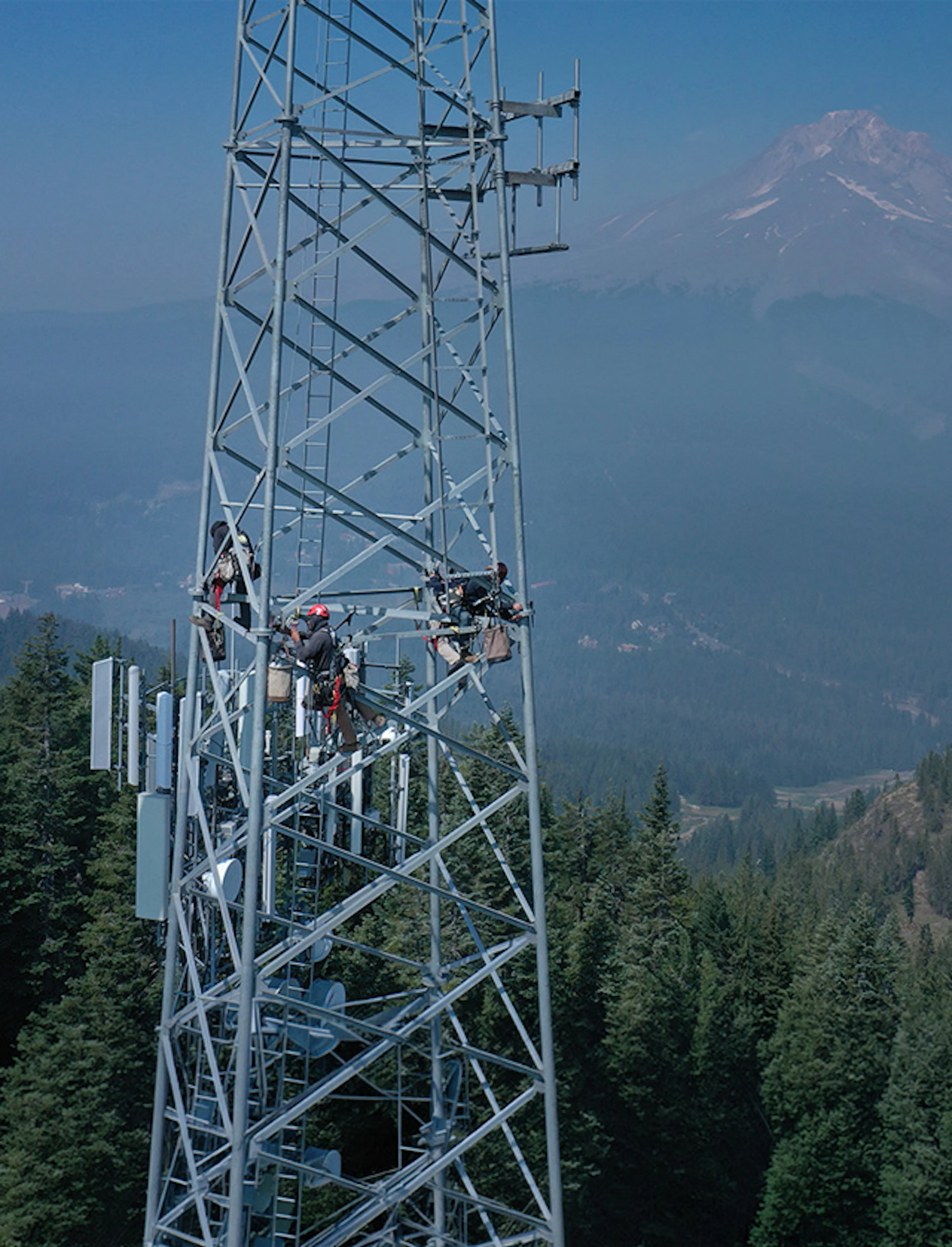 Technicians working atop a lattice communications tower — Day Wireless