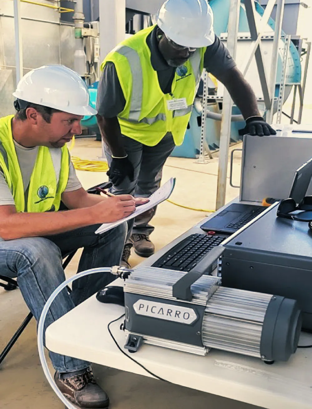 Field technicians operating Picarro gas analysis equipment on site