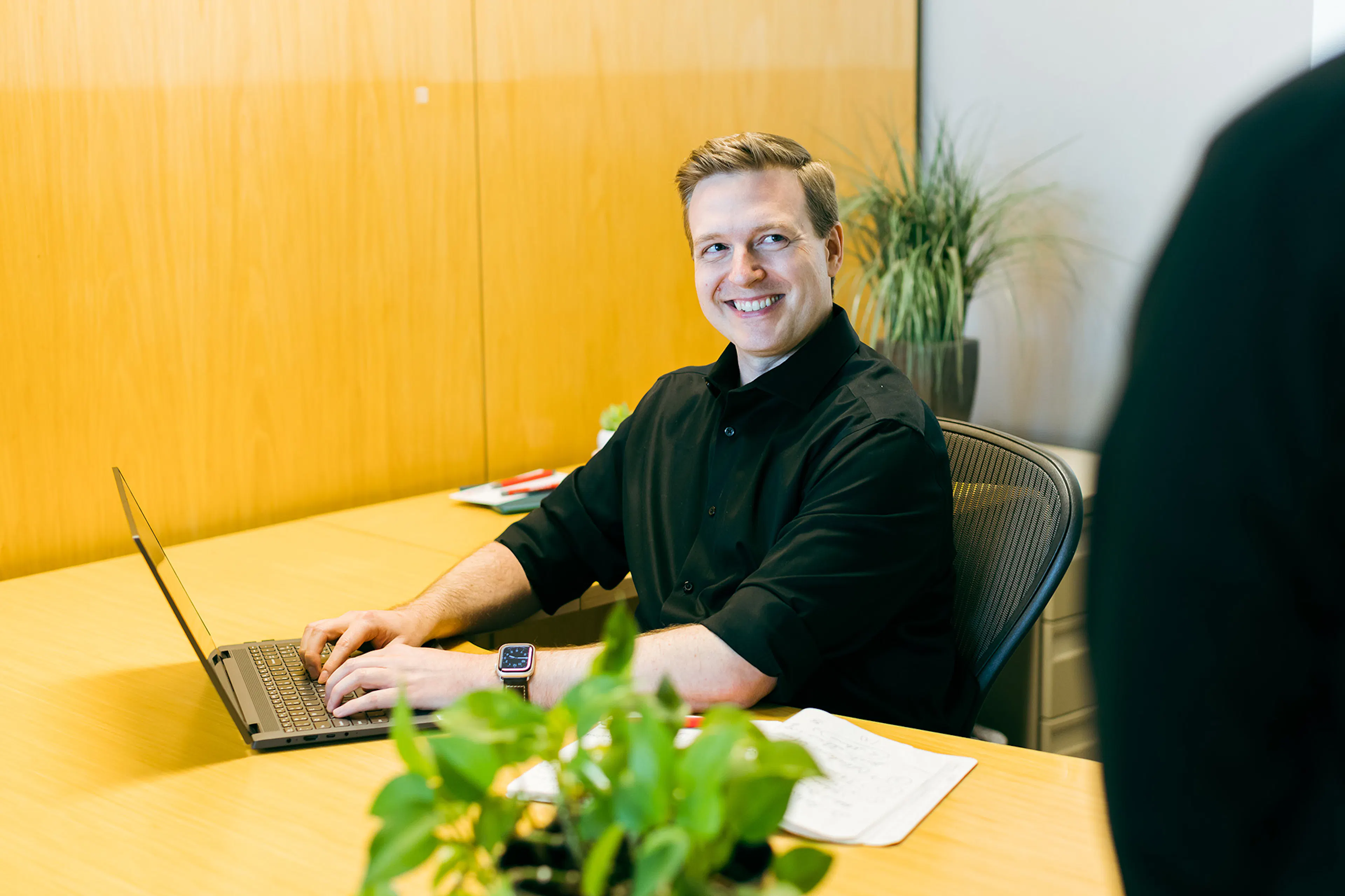 Luxent consultant working at a laptop in the office