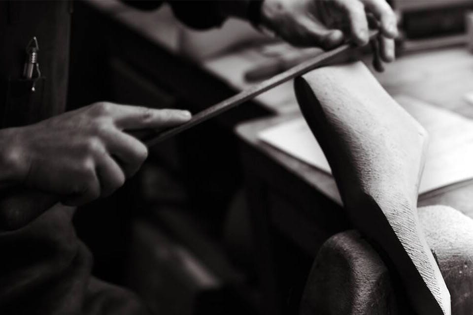 Working on the form to produce a bespoke shoe.