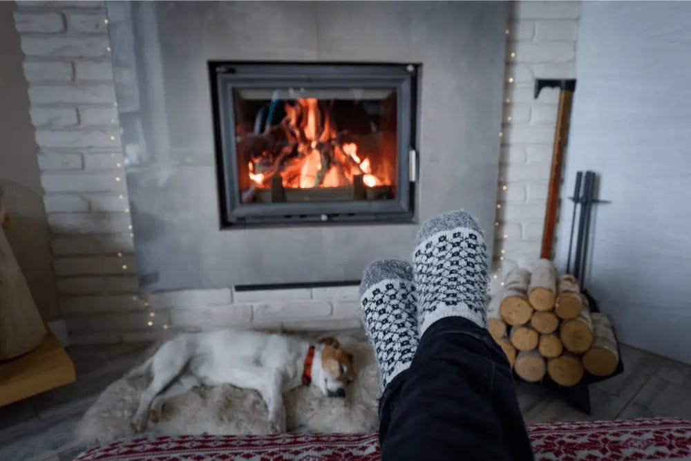 feet warming by a fireplace