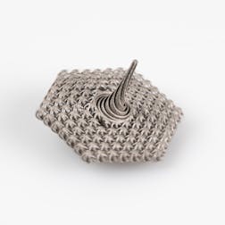 Complex-shaped tungsten spinning top, resembling an intricate piece of chainmail, crafted through selective laser beam melting.