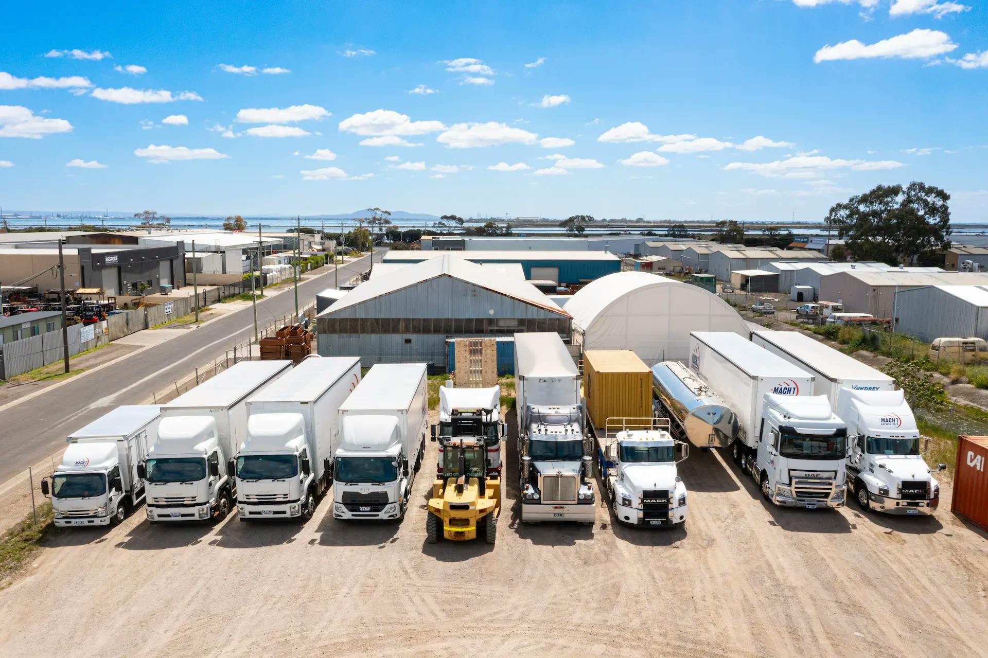 MACH 1 yard with trucks, aerial view with forklift in center.