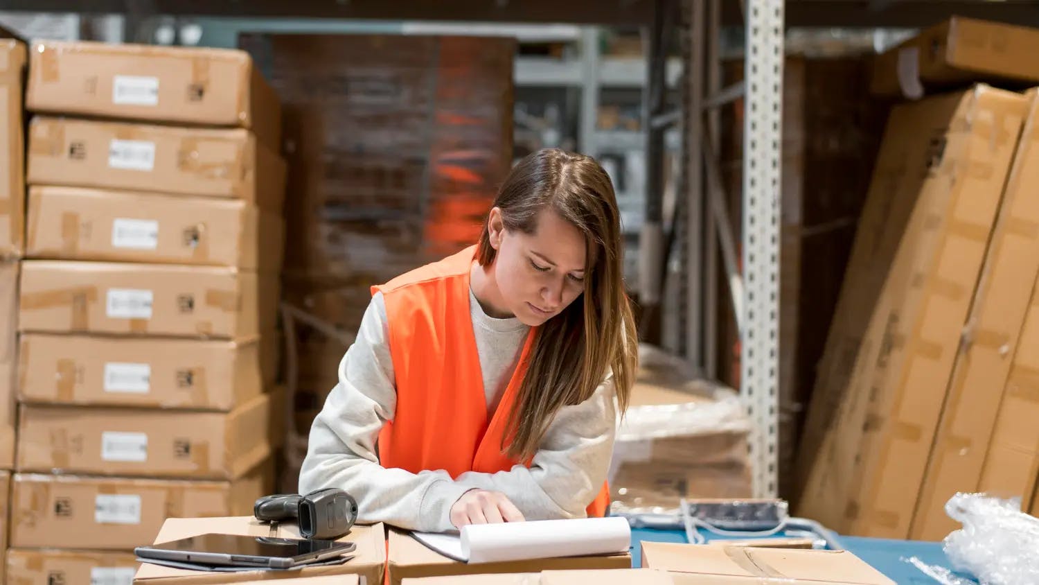 Woman at table in warehouse