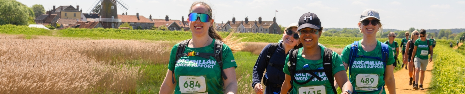 Image shows four woman walking and smiling at the camera, whilst taking on their Mighty Hike.