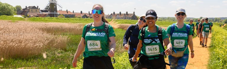 Image shows four woman walking and smiling at the camera, whilst taking on their Mighty Hike.