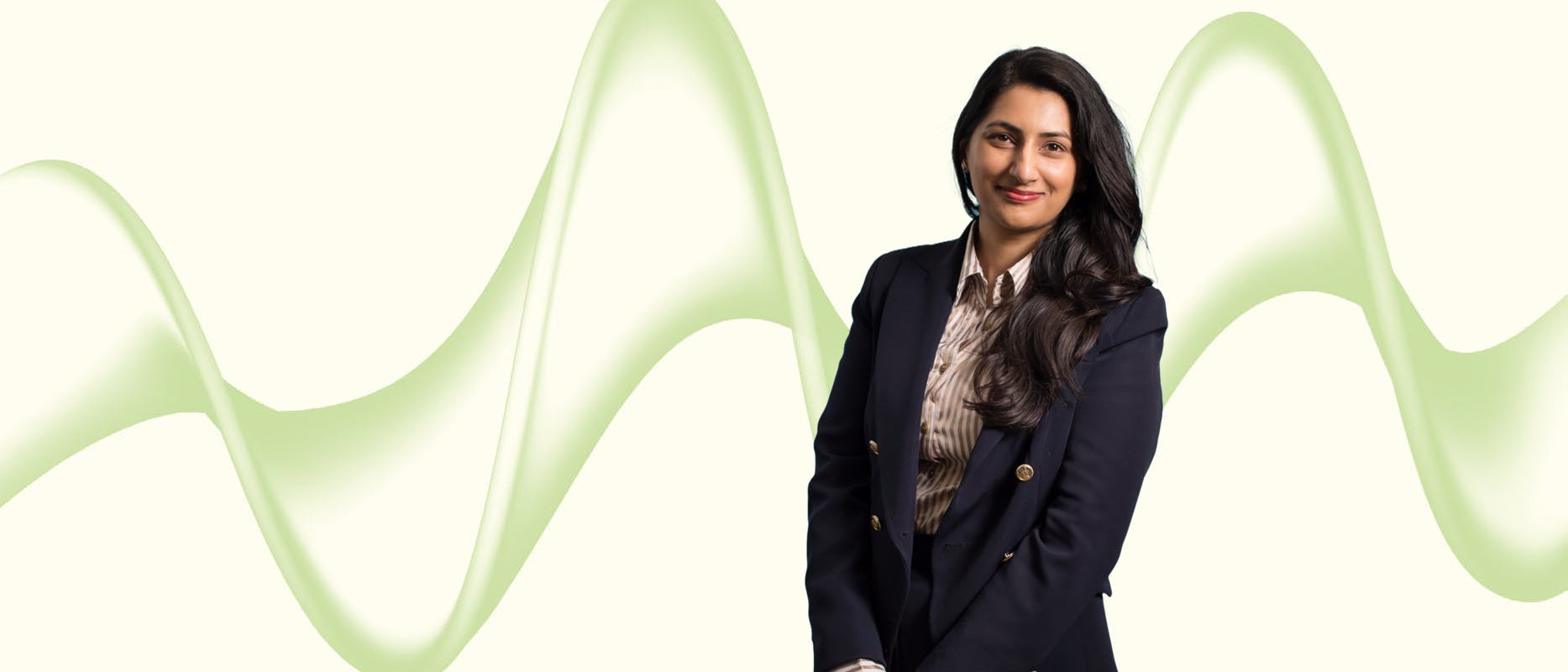 image of a woman in a navy jacket on a cream background with a green wave