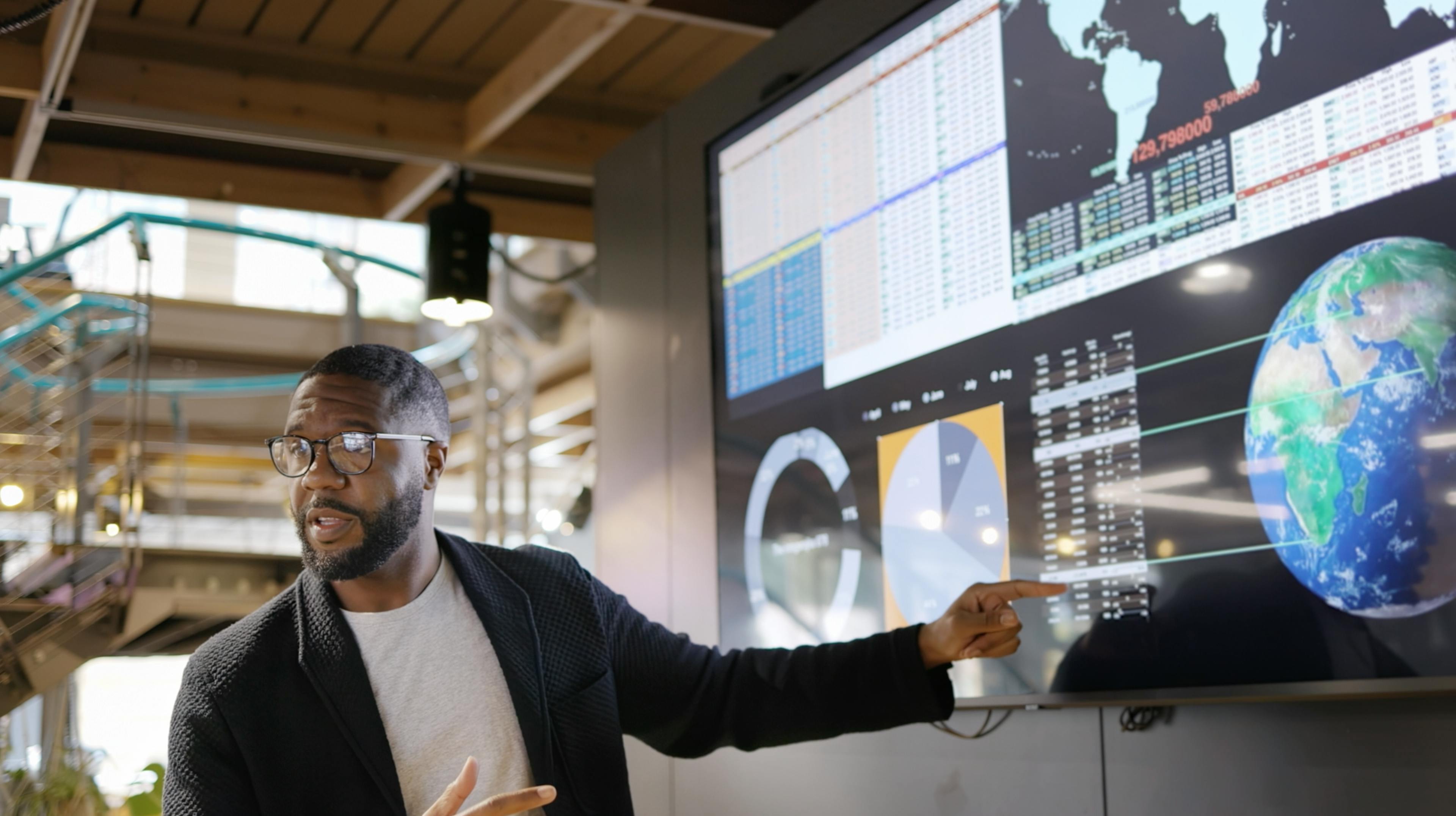 Man presenting data on a tv screen