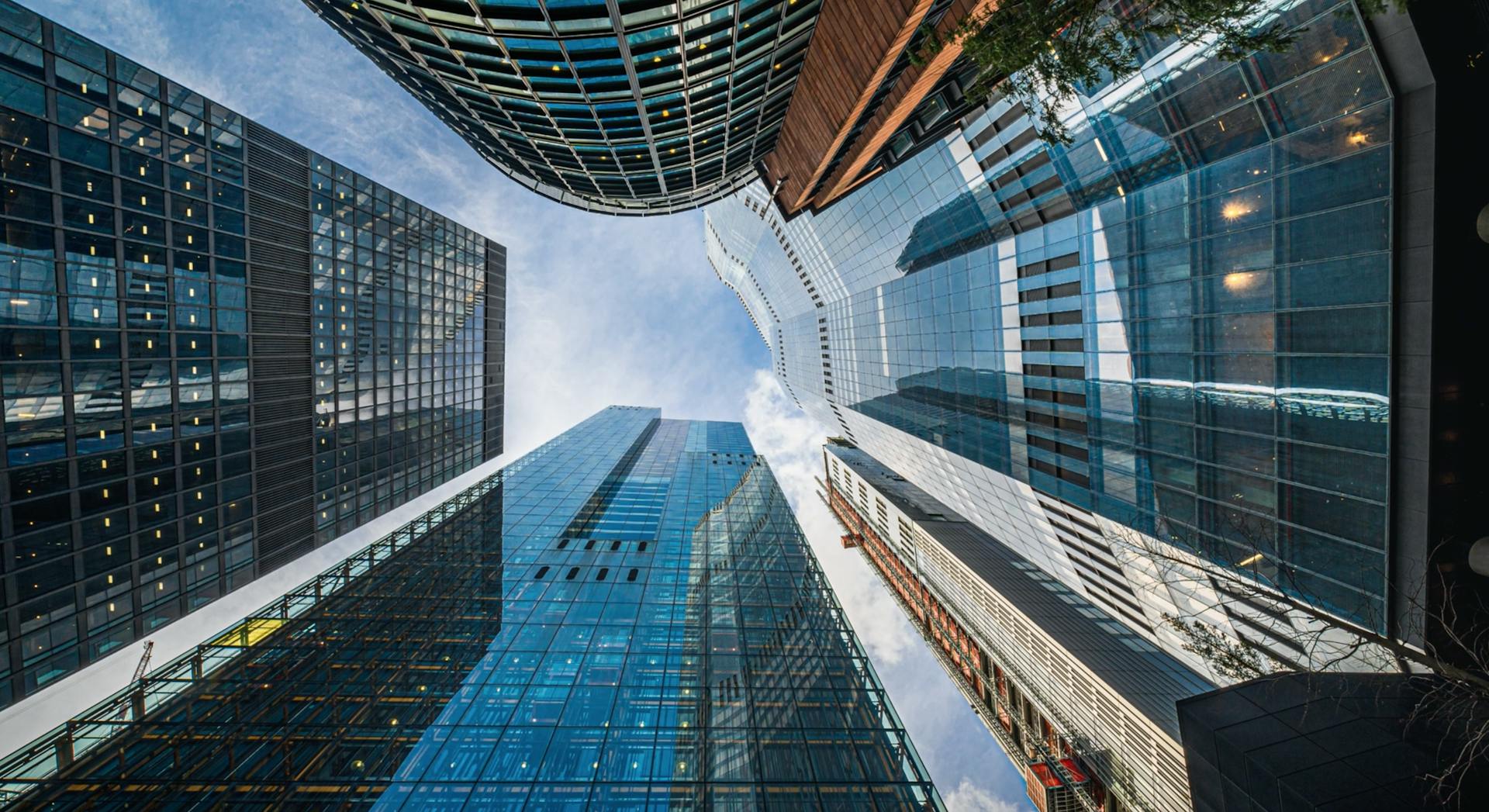 High-rise office buildings shot from a low angle with a blue sky above