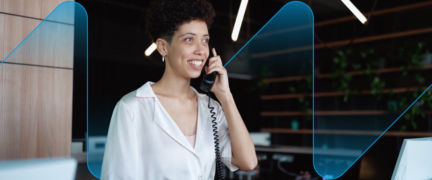 Receptionist answering phone in a modern office