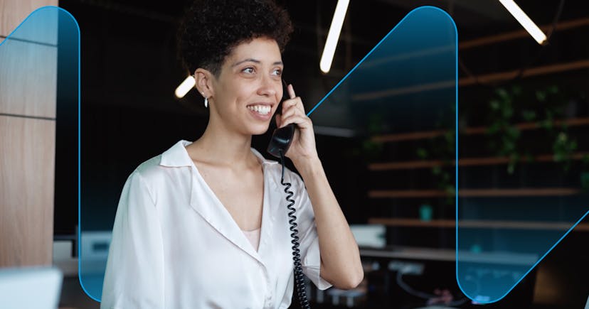 Receptionist answering phone is a modern office