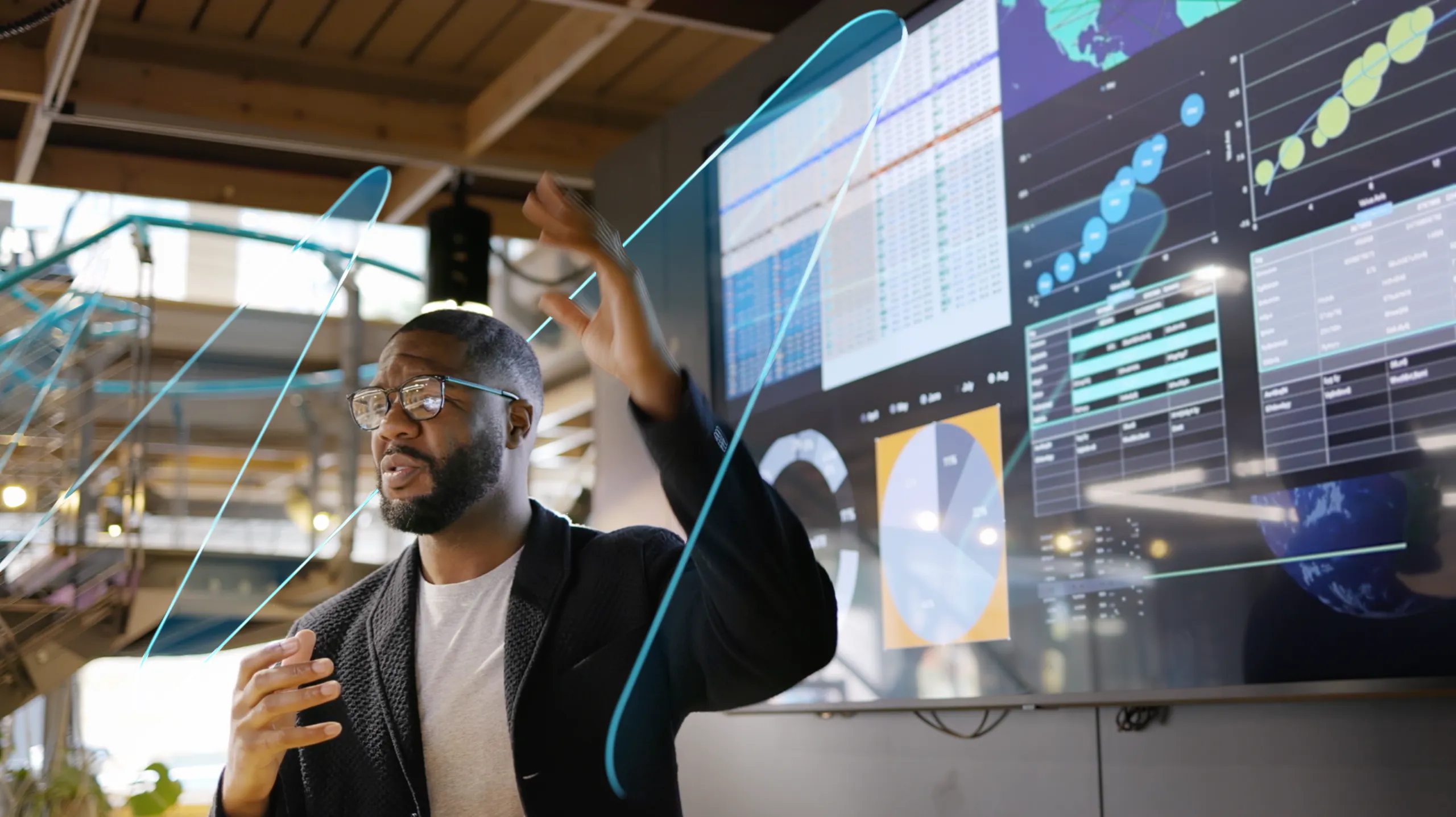 A man presenting on screen with The Macro Wave graphic moving by him