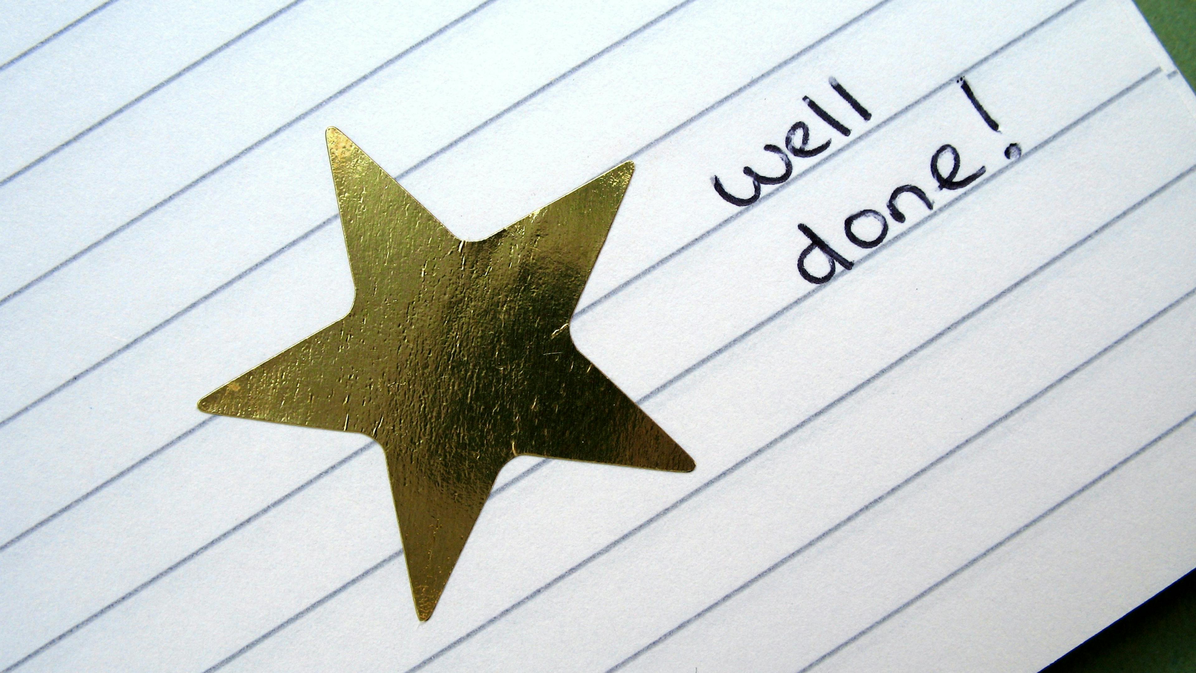 Gold star and well done on lined paper