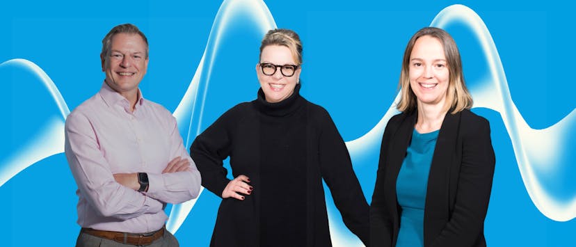 two women and a man on a blue banner

