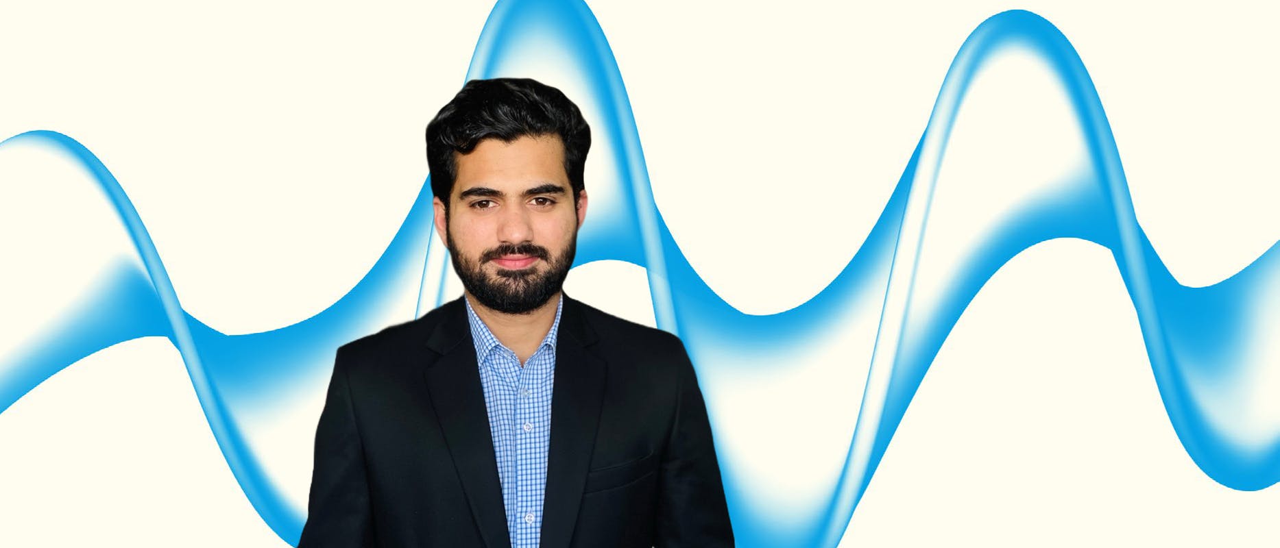 image of a man with black hair and beard in a blue shirt with black blazer on a cream background with a blue swirl