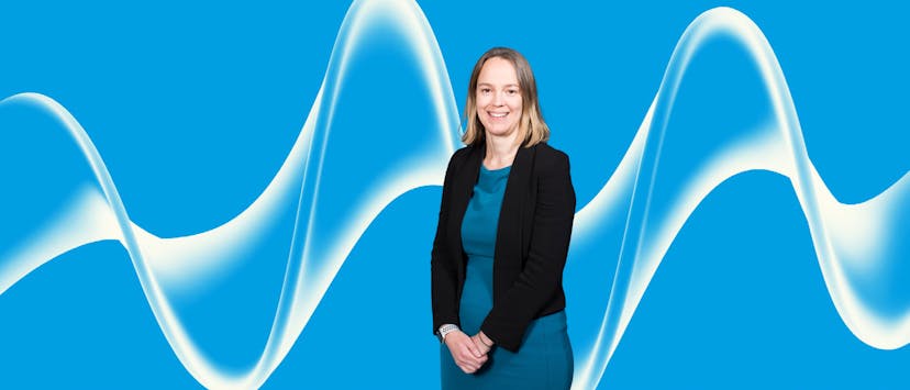 image of a woman in a blue dress and black jacket with brown hair on a blue background with a white swirl pattern