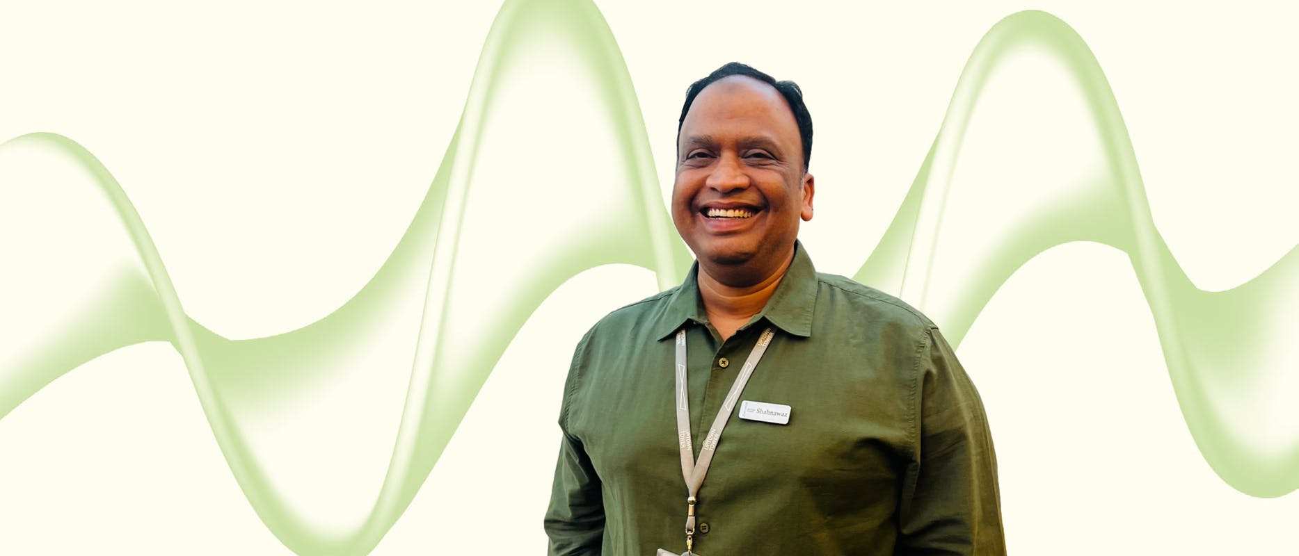 image of a man with a green shirt black hair on a cream background