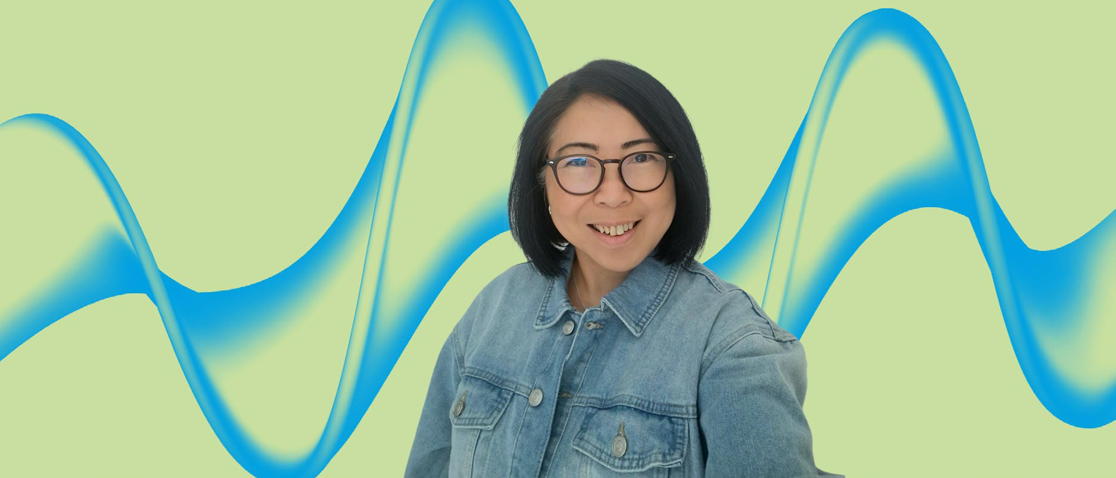 image of a woman with black hair and glasses in a denim jacket with green background