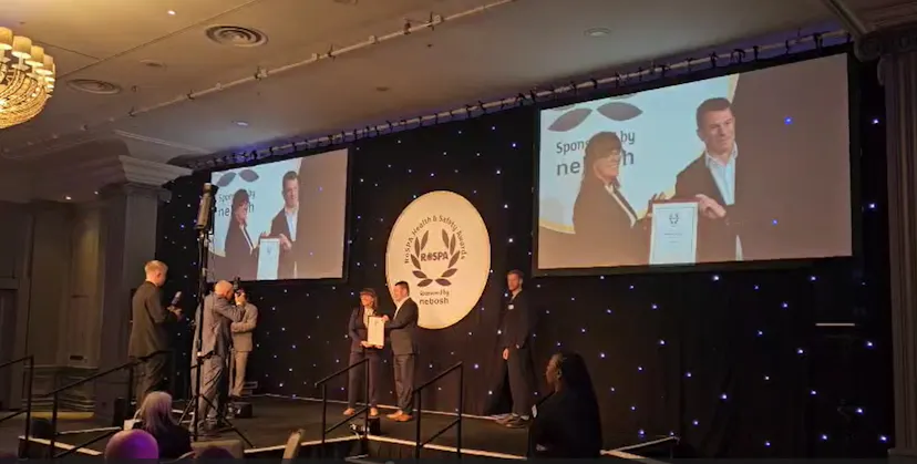 image of Macro rep accepting award on a stage