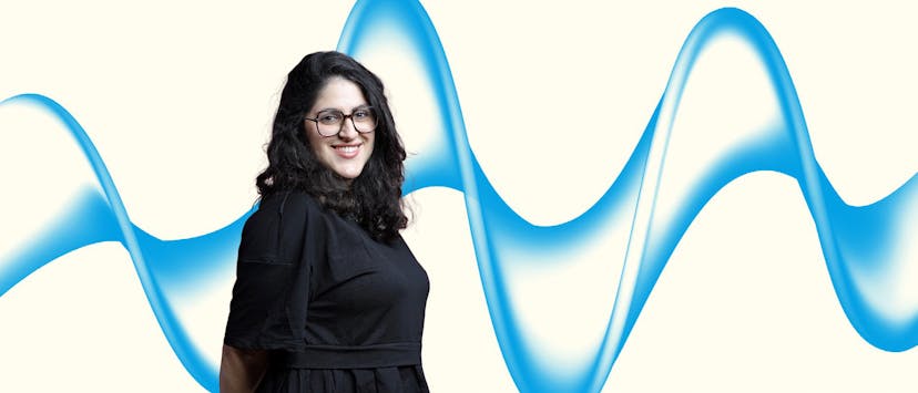 image of a woman with black hair and glasses on a cream banner with a blue wave