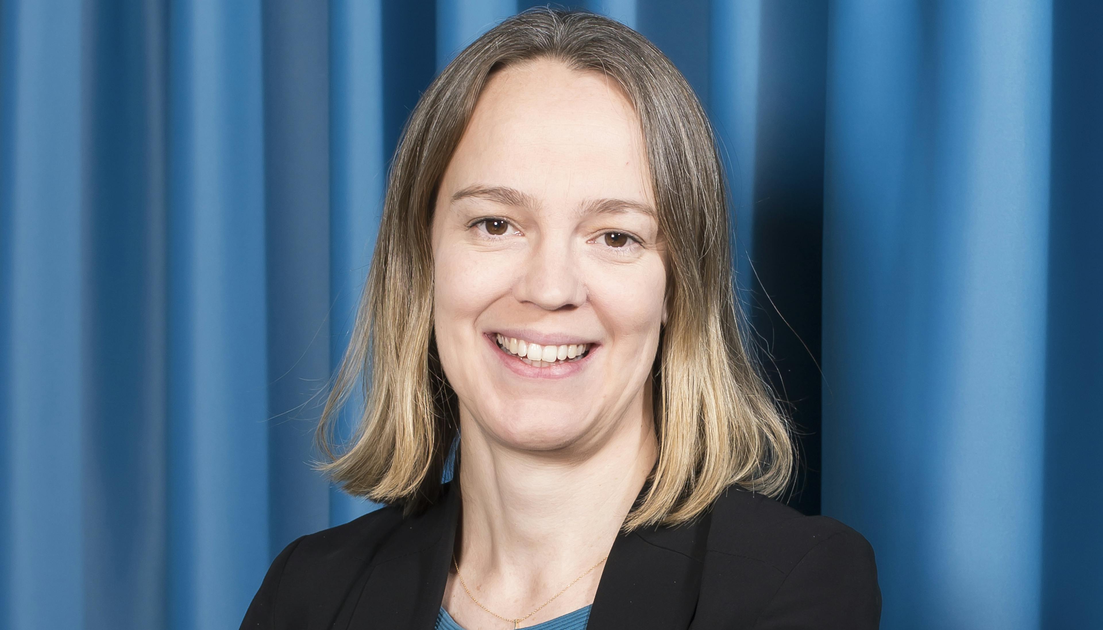 woman with blond hair on a blue background in a blue dress 