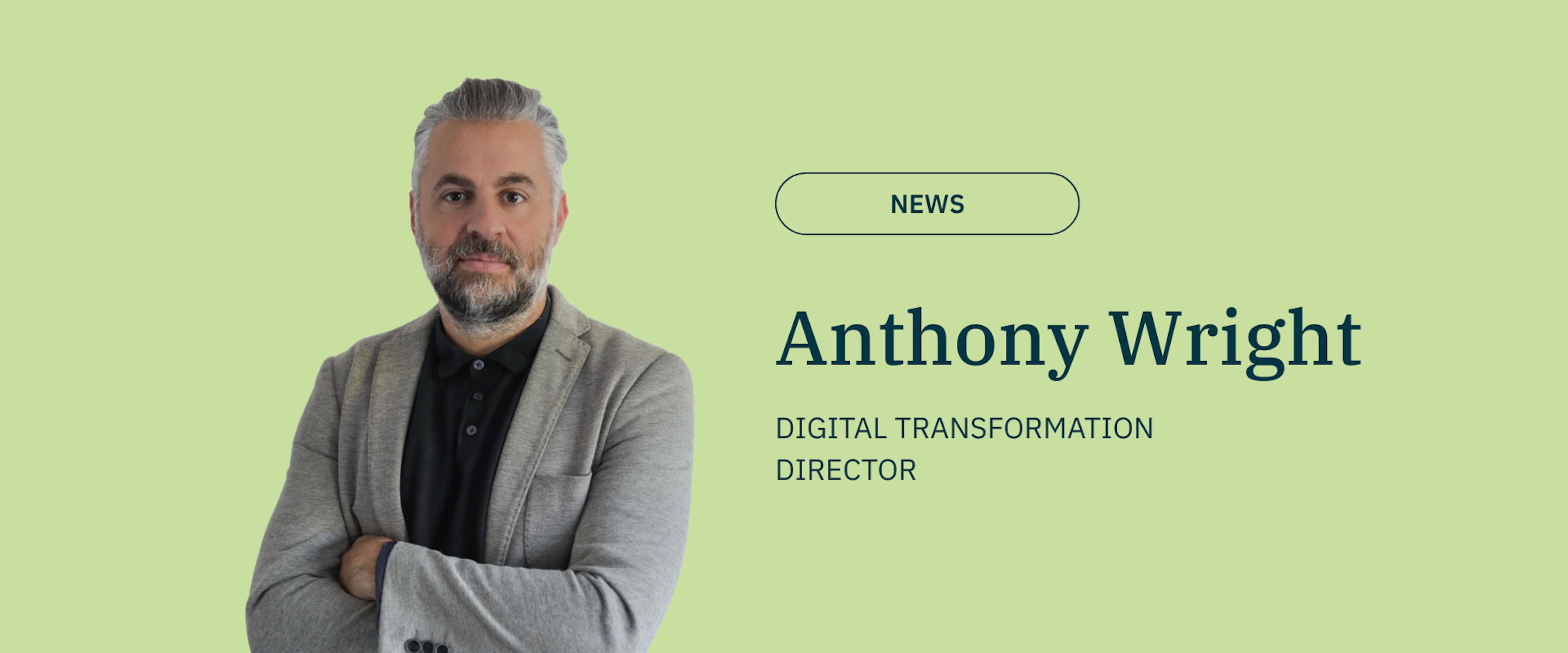 image of a man with grey hair and beard on a green back ground with text wearing black top and grey blazer