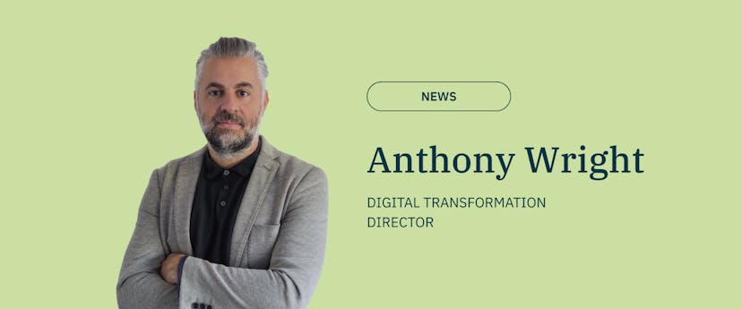 image of a man with grey hair and beard on a green back ground with text wearing black top and grey blazer