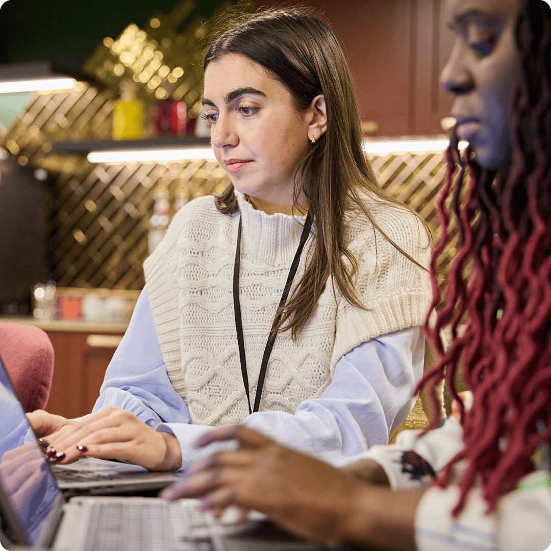 image of two women at laptops
