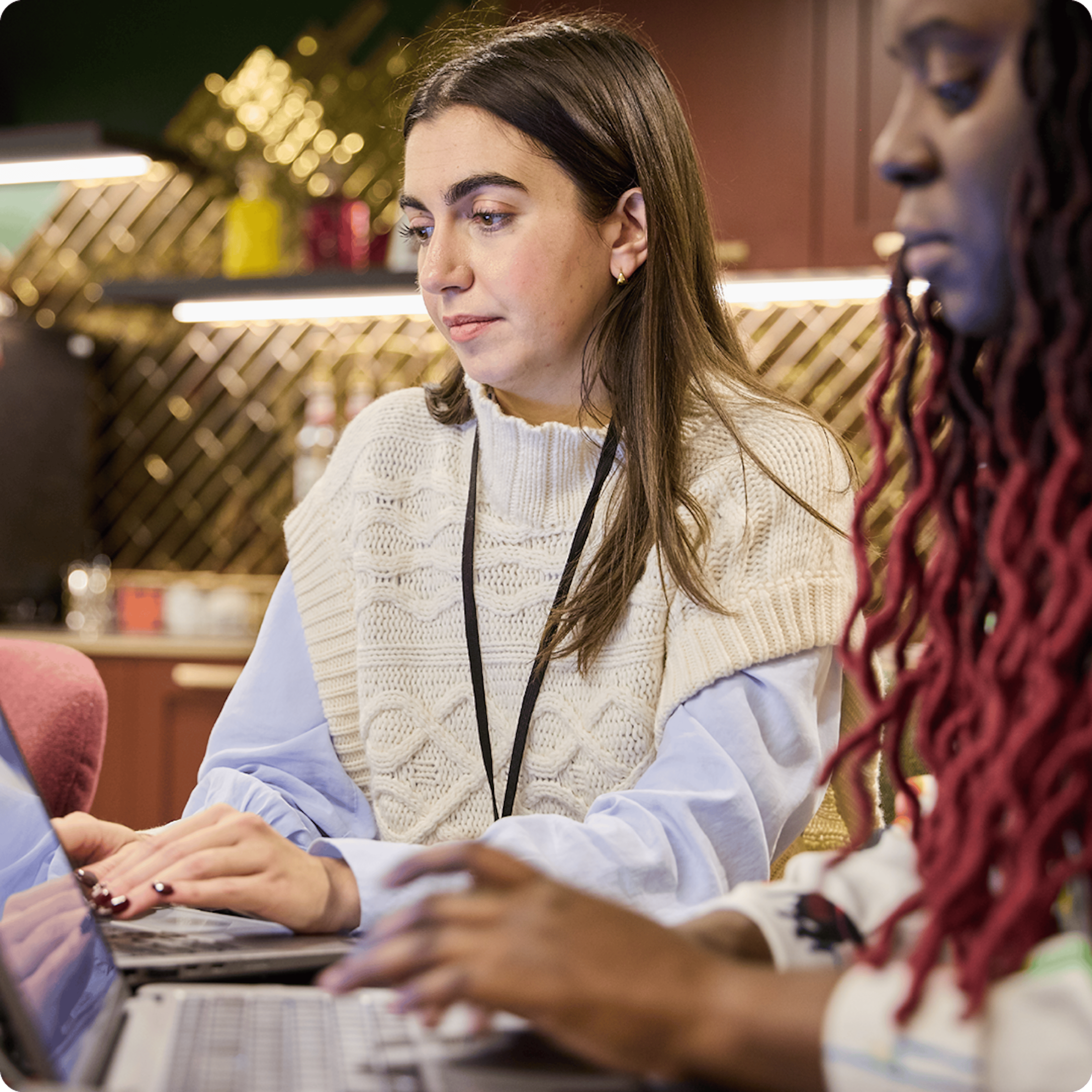 image of two women at laptops