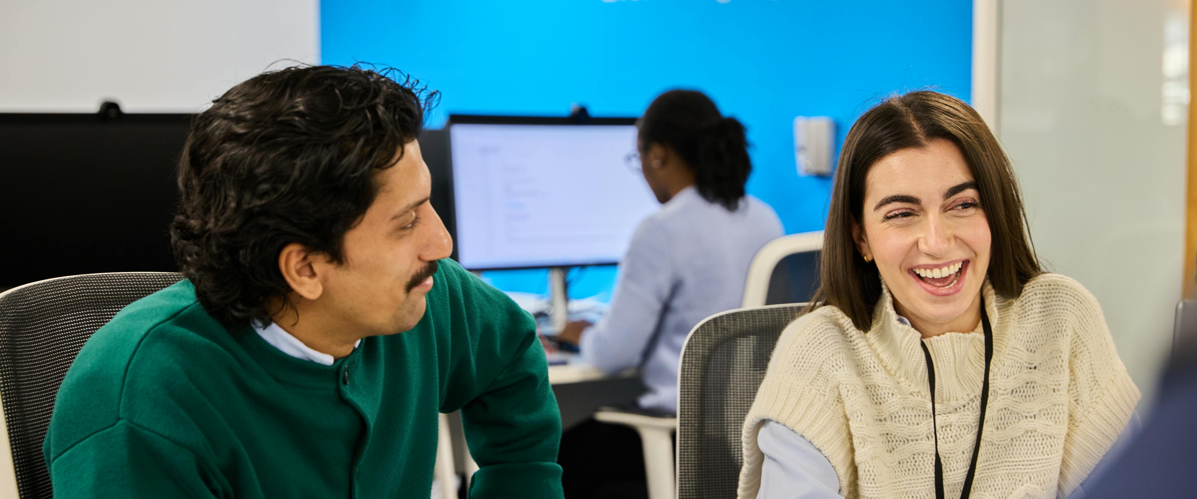 image of a man and woman with a macro background in an open office
