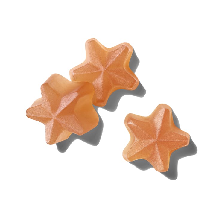 Close up image of Such Good Skin star shaped pink chewable gummies.