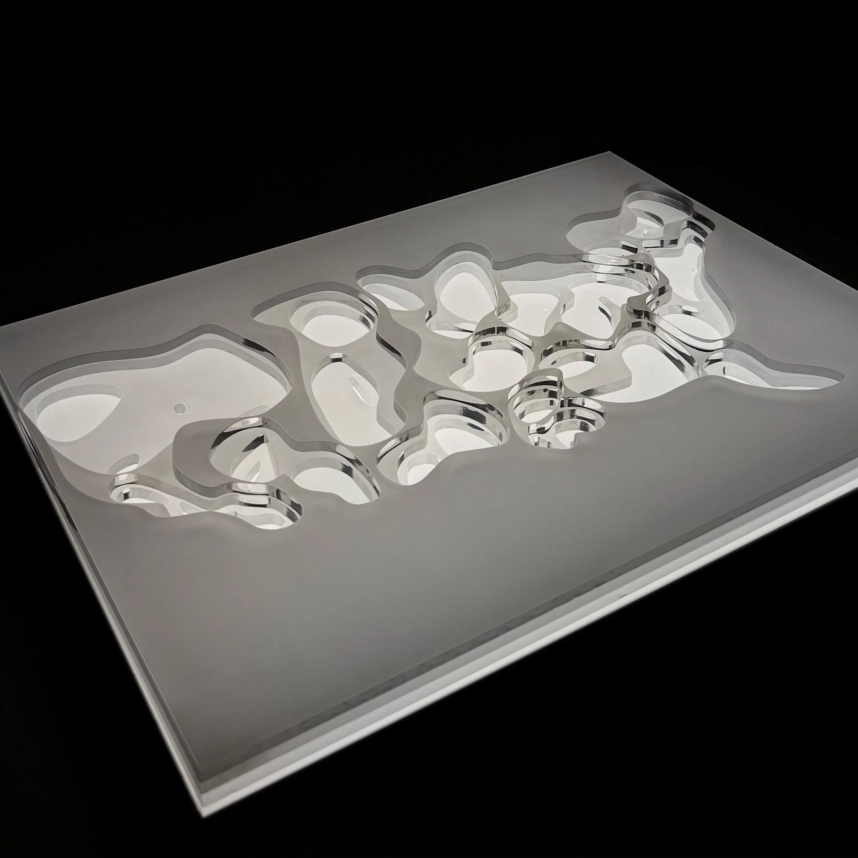 Picture of data sculpture, map lit from below and cut out to show light pollution levels