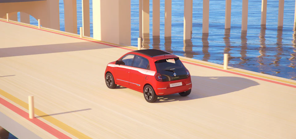 A red Renault Twingo model on the road.