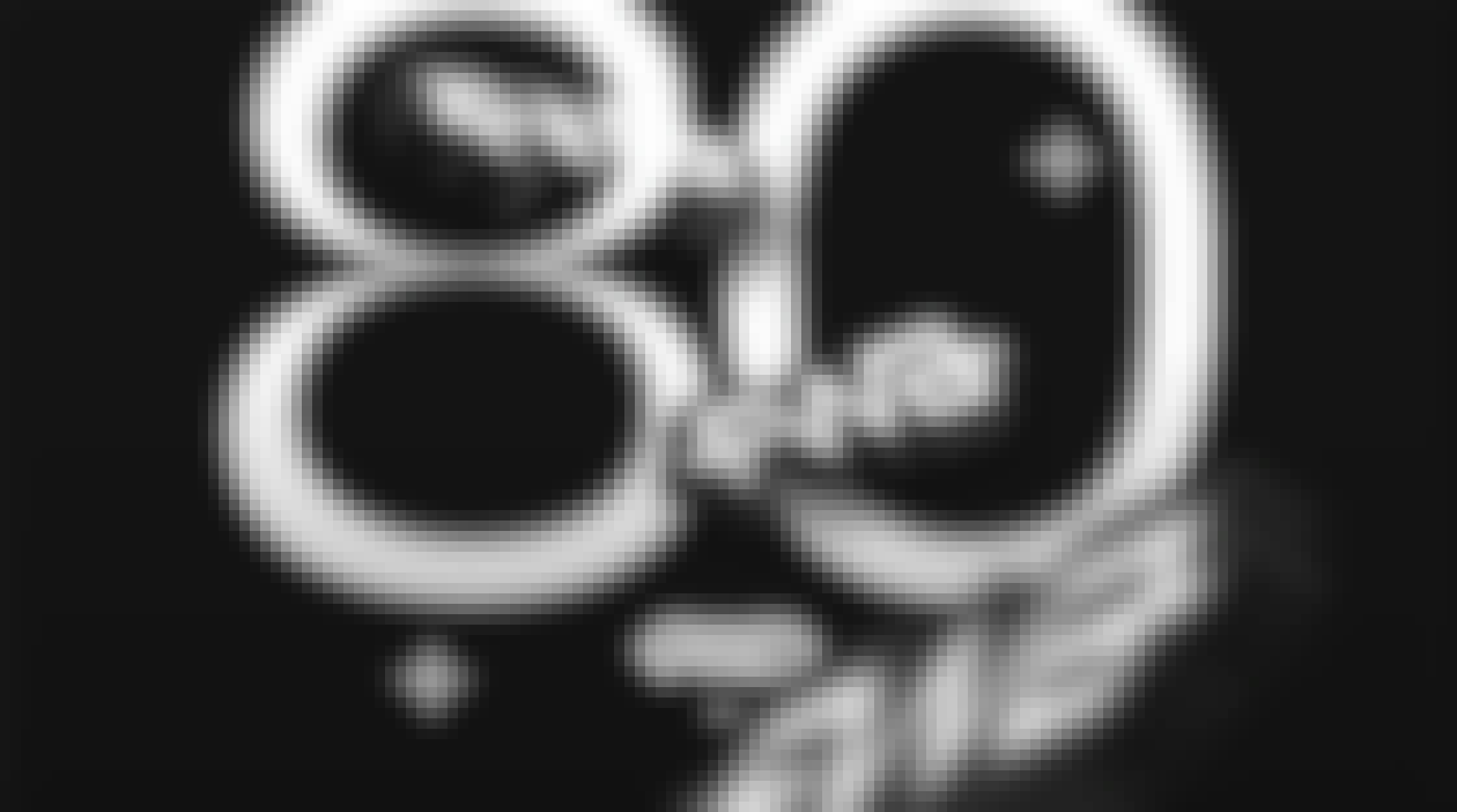 80 awards won, the 3D logo of the FWA is positioned at different depth of field in the image. One is placed behind the top loop of the number 8, the second in front of the 0 and the last one is blurred and at the very foreground.