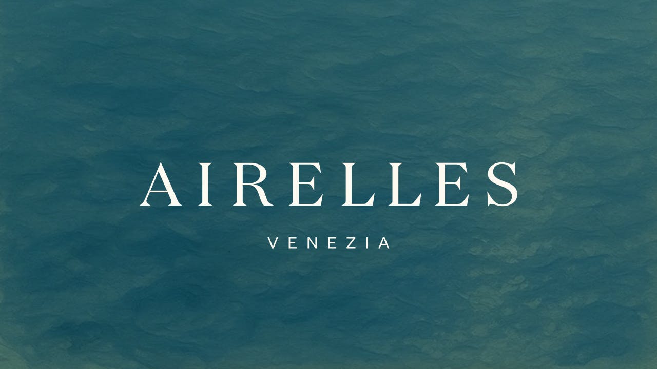 Airelles Venezia logo with blue water in the background.
