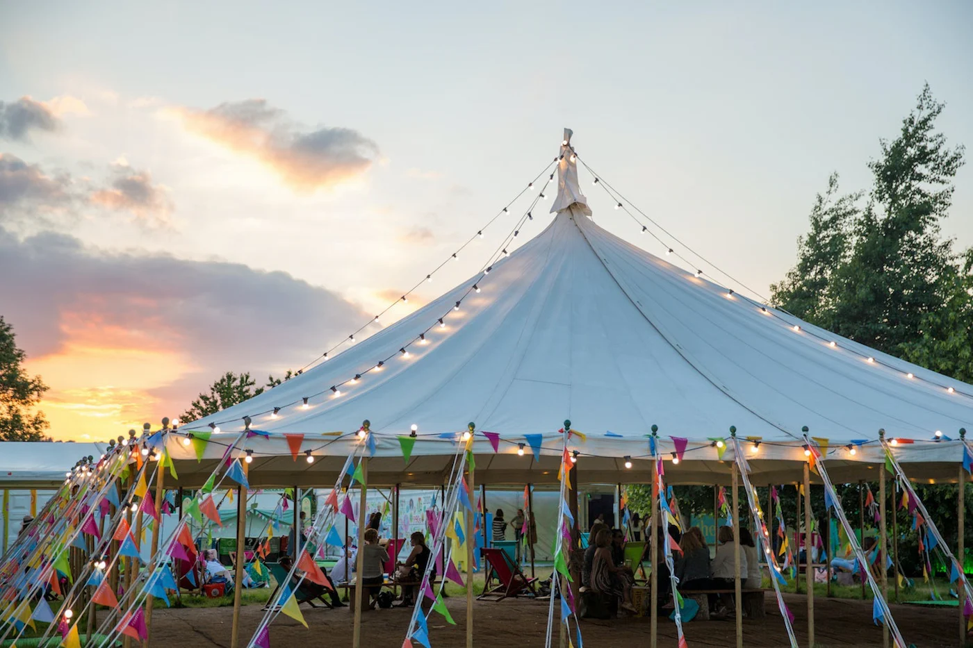 A picture of a carousel at sunset.