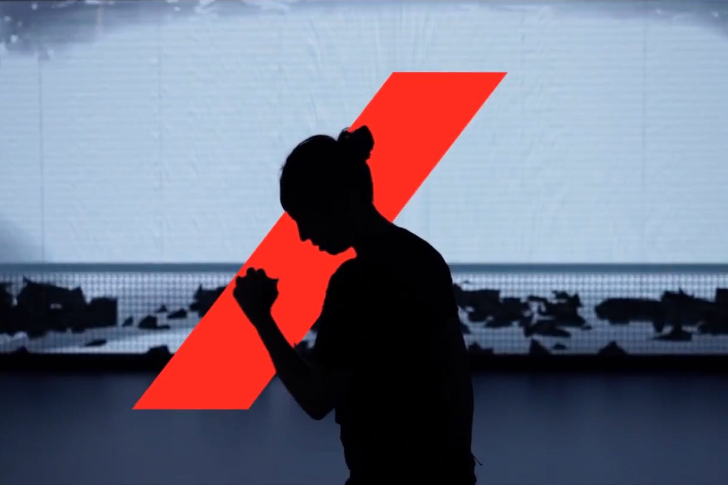 Silhouette of a women in front of the Axa red bar