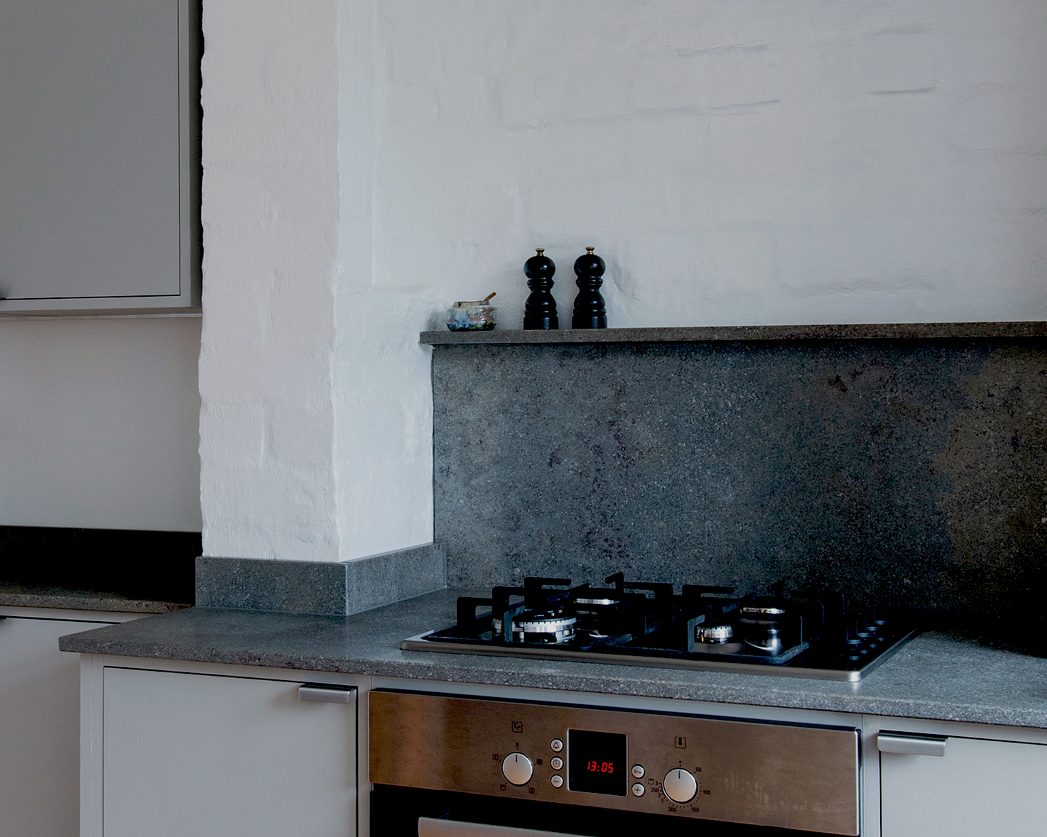 Minimal warm grey painted Ma-kon kitchen with limestone worktops.