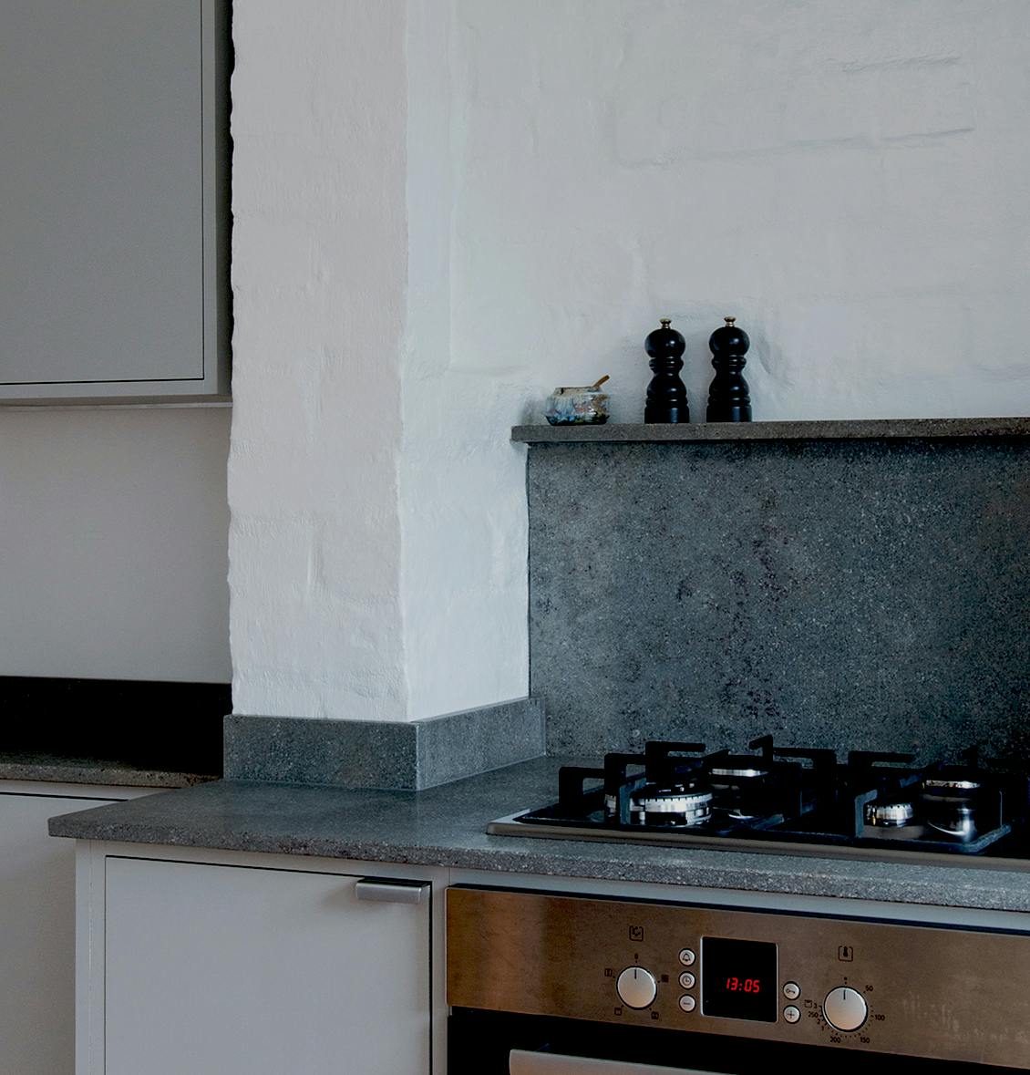 Minimal warm grey painted Ma-kon kitchen with limestone worktops.