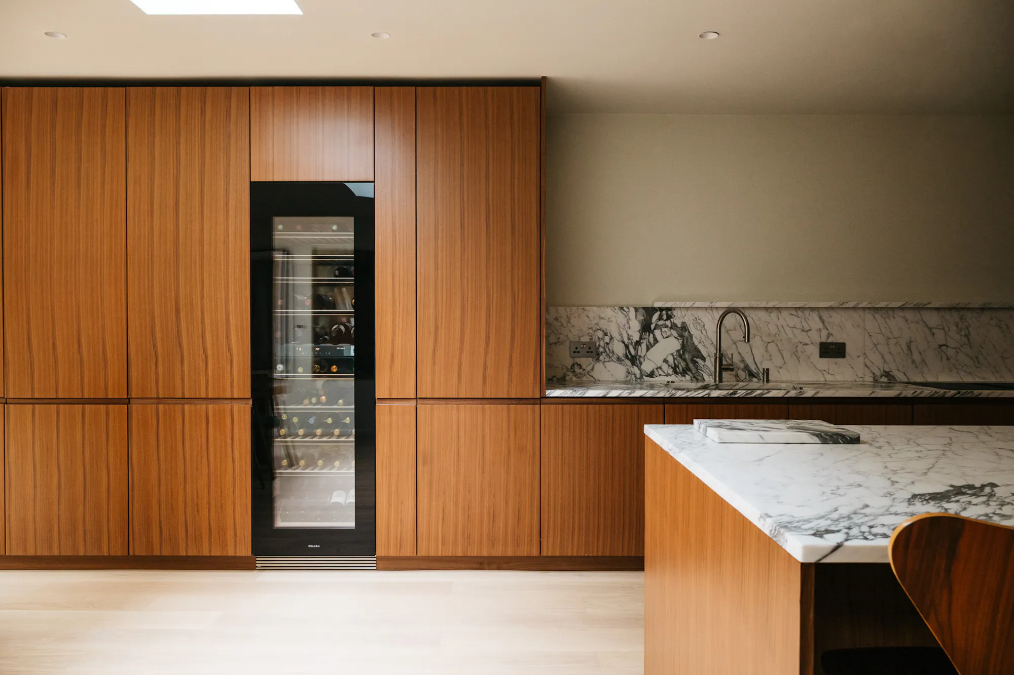 Contemporary walnut timber and marble Ma-kon kitchen.