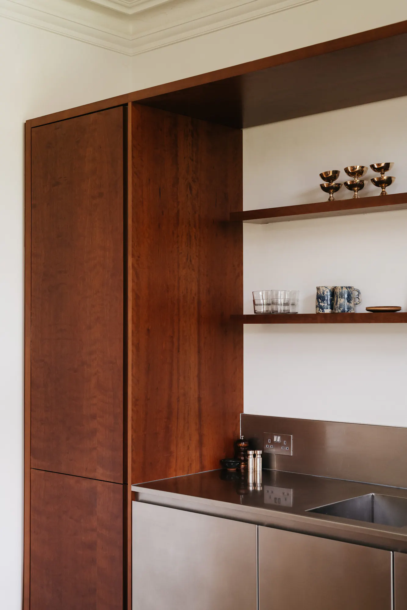 Cherry timber, black marble and stainless steel Ma-kon kitchen.
