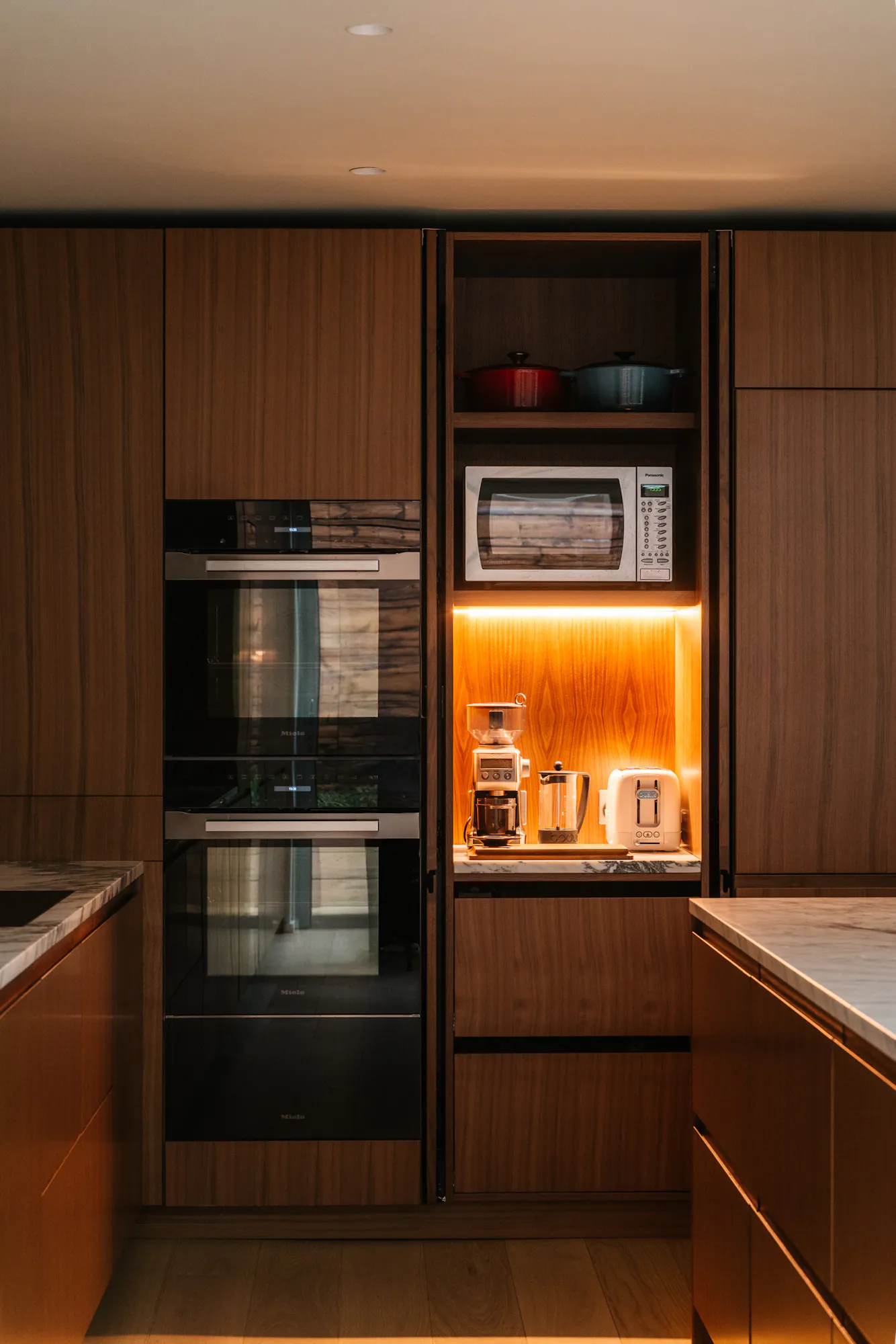 Contemporary walnut timber and arabescato marble Ma-kon kitchen.