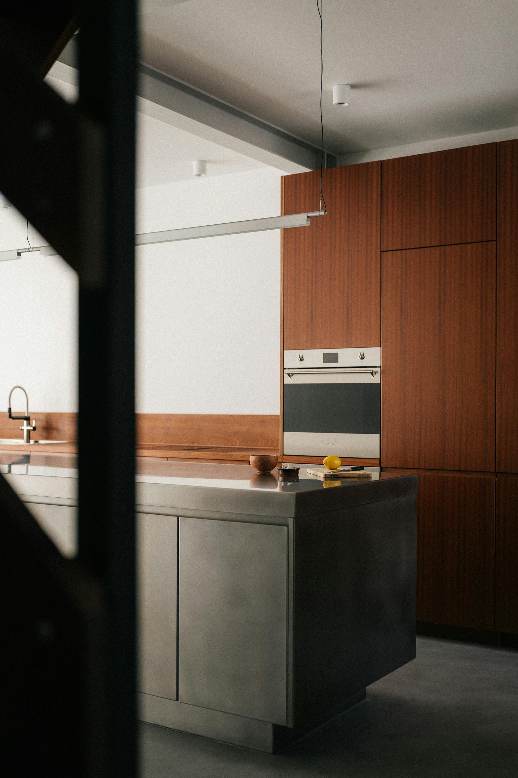 Contemporary sapele and stainless steel Ma-kon kitchen.