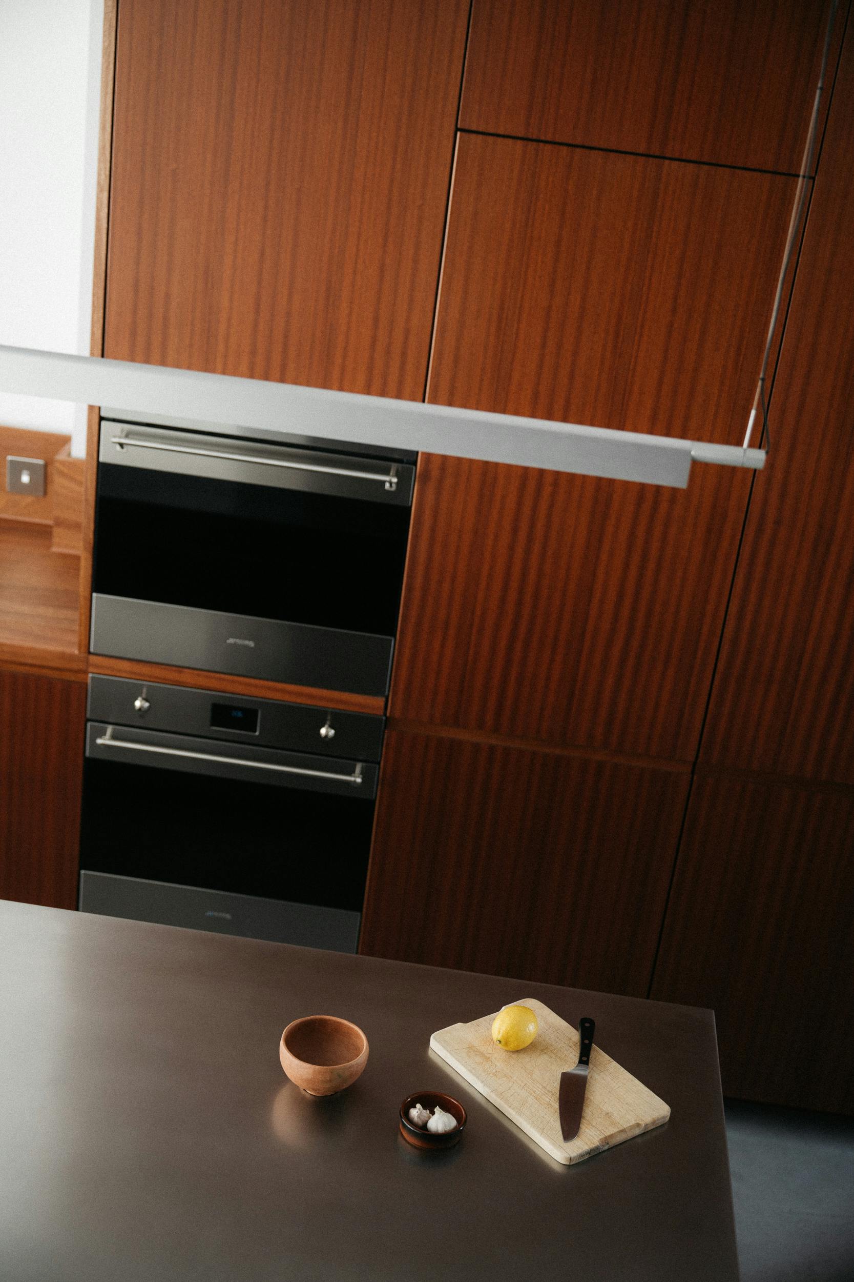 Contemporary sapele and stainless steel Ma-kon kitchen.