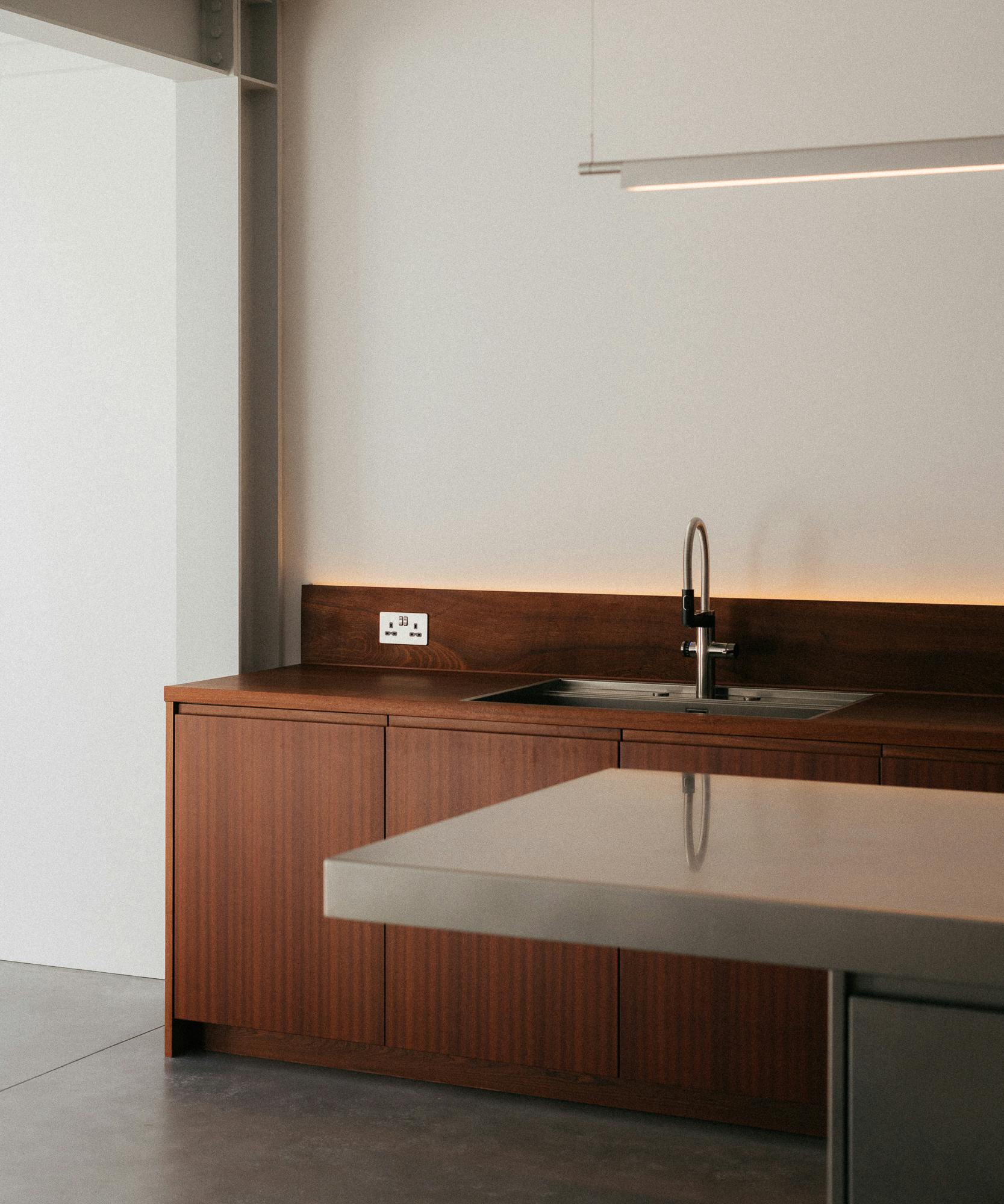 Contemporary sapele and stainless steel Ma-kon kitchen.