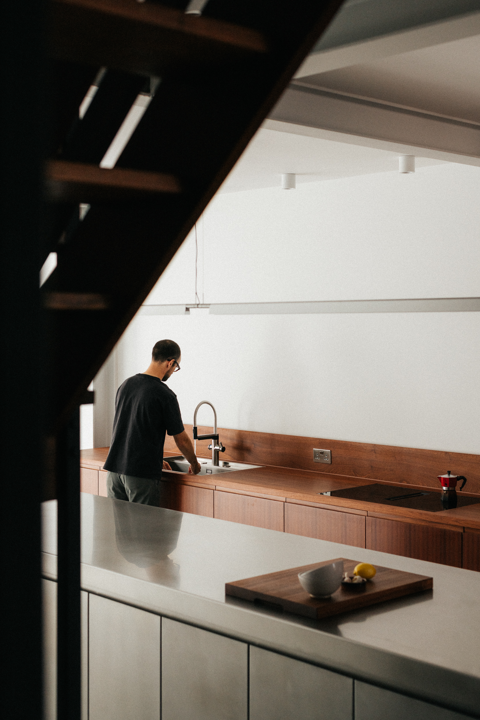 Contemporary dark sapele timber and stainless steel Ma-kon kitchen.