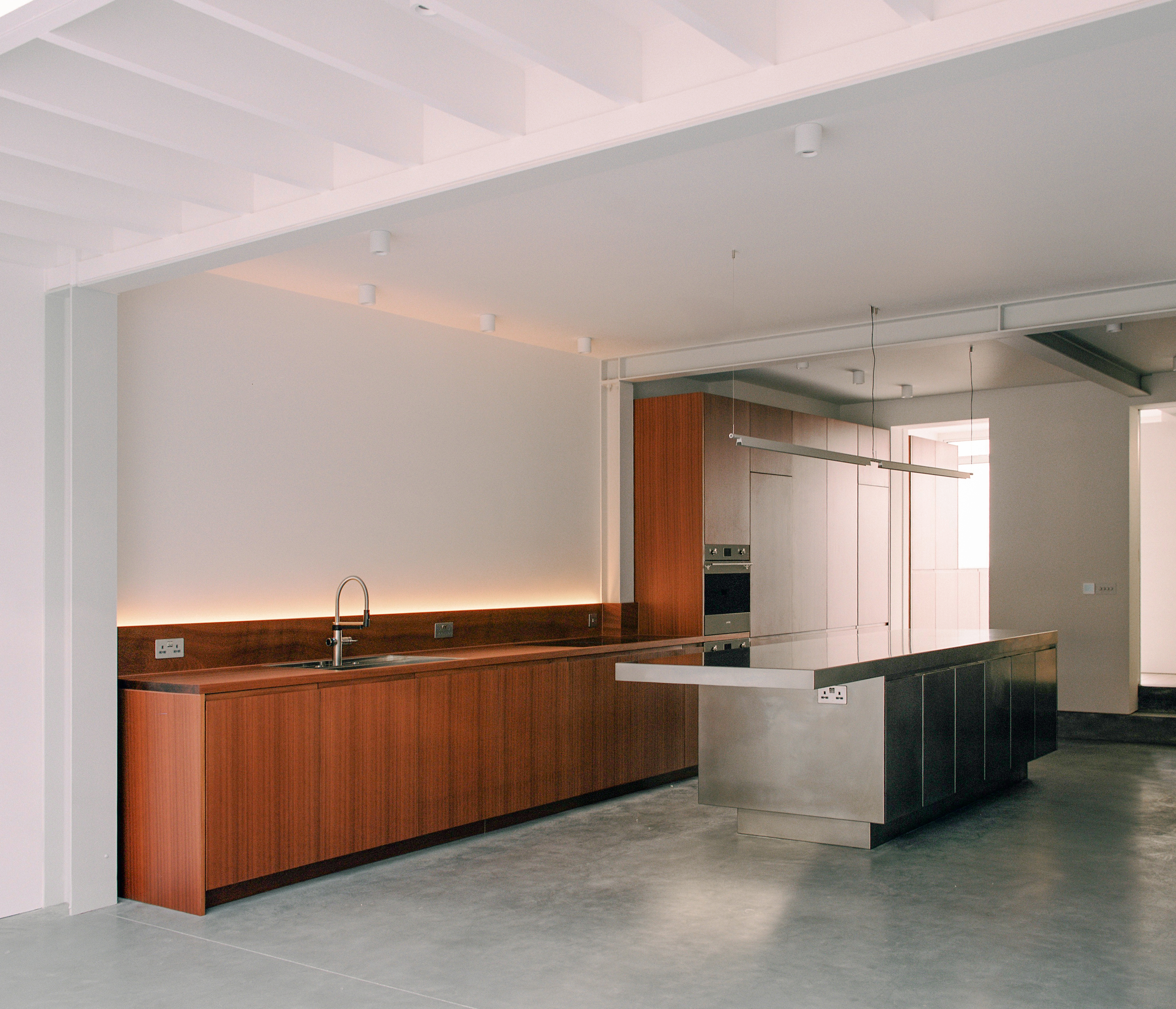 Contemporary sapele and stainless steel Ma-kon kitchen.