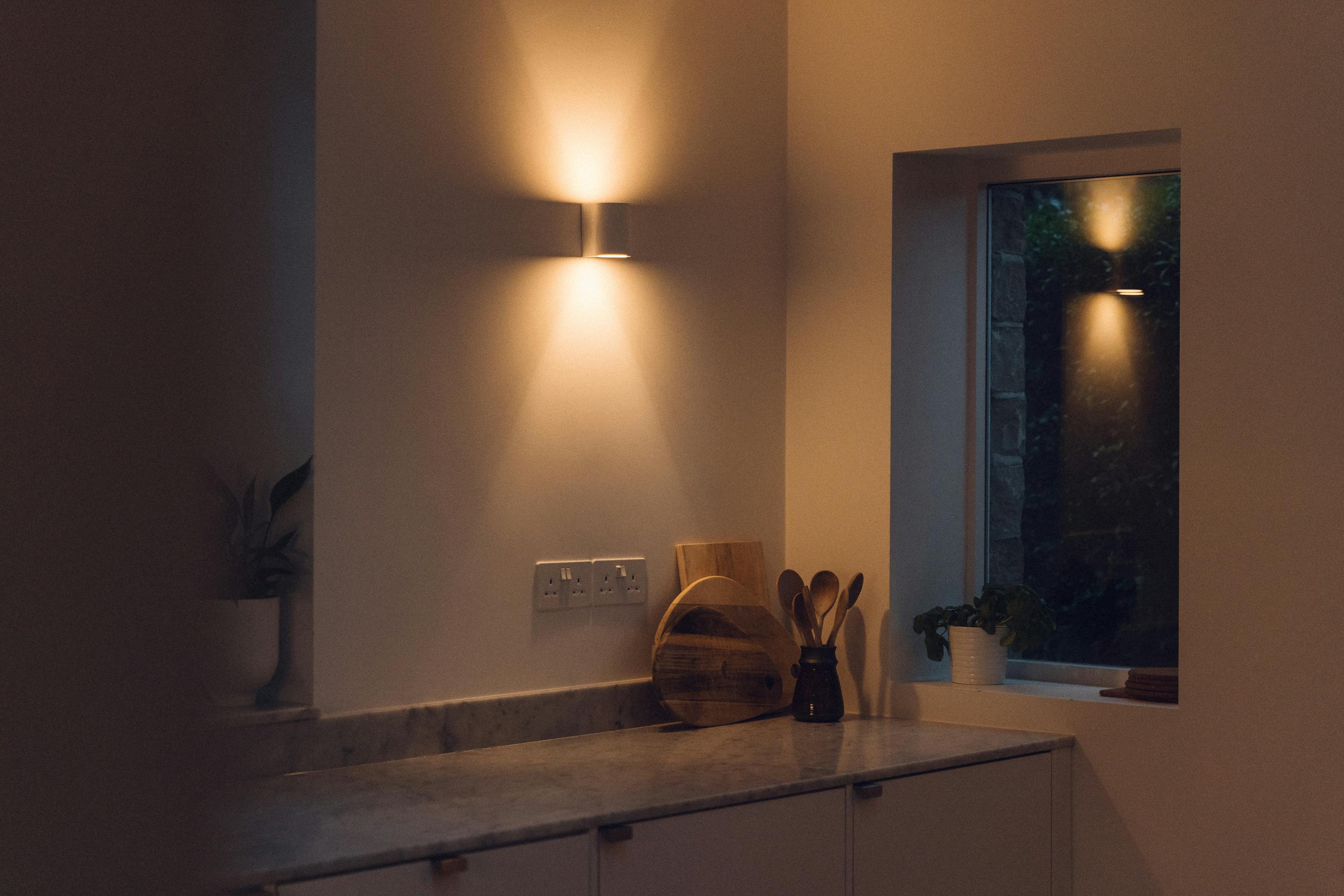 Minimal white painted Ma-kon kitchen with Carrara marble worktop.